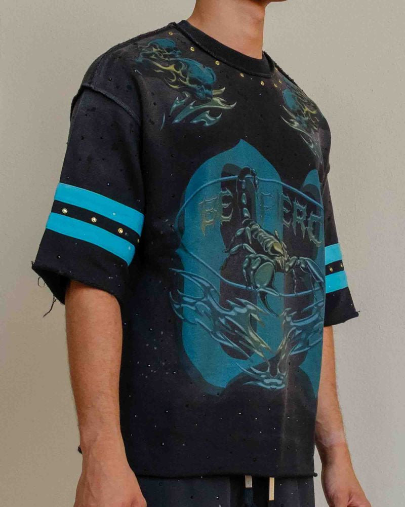 Person wearing a black and blue graphic t-shirt with matching pants on a plain background