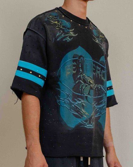 Person wearing a black and blue graphic t-shirt with matching pants on a plain background