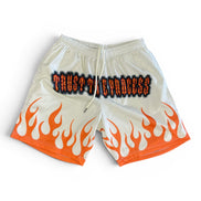 Beige shorts with orange flames and black text on a white background