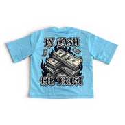 Light blue t-shirt with money graphic and 'In Cash We Trust' text on a white background