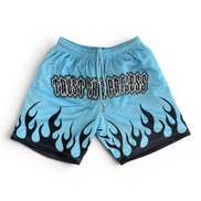Light blue shorts with black flame patterns and text on a white background