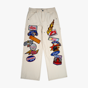 Beige pants with various patches on a white background