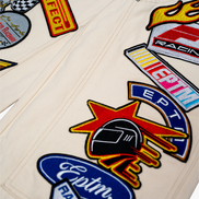 Collection of racing-themed patches on a beige background