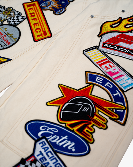 Collection of racing-themed patches on a beige background