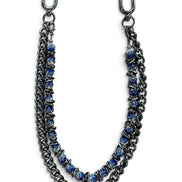 A double-strand chain bracelet featuring dark gunmetal silver-tone metal links and blue faceted beads, displayed on a clean white background.
