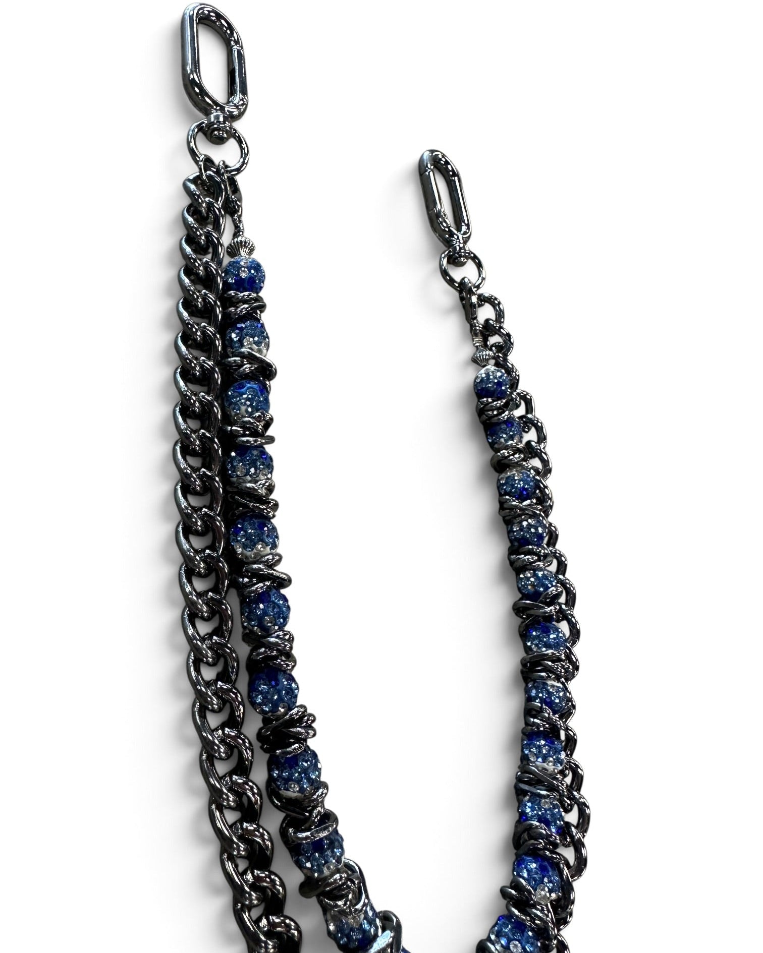 A double-strand chain strap featuring one dark gunmetal chain and one chain embellished with textured blue beads, both finished with silver-tone lobster clasp ends, shown on a plain white background.