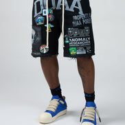 Person wearing black shorts with text and graphics, blue sneakers, and socks on a white background