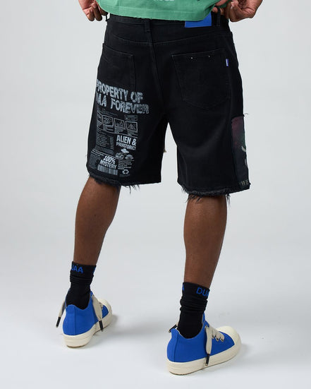 Person wearing black shorts with text and graphics on a white background