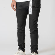 Person wearing black pants with a visible brand label on a white background