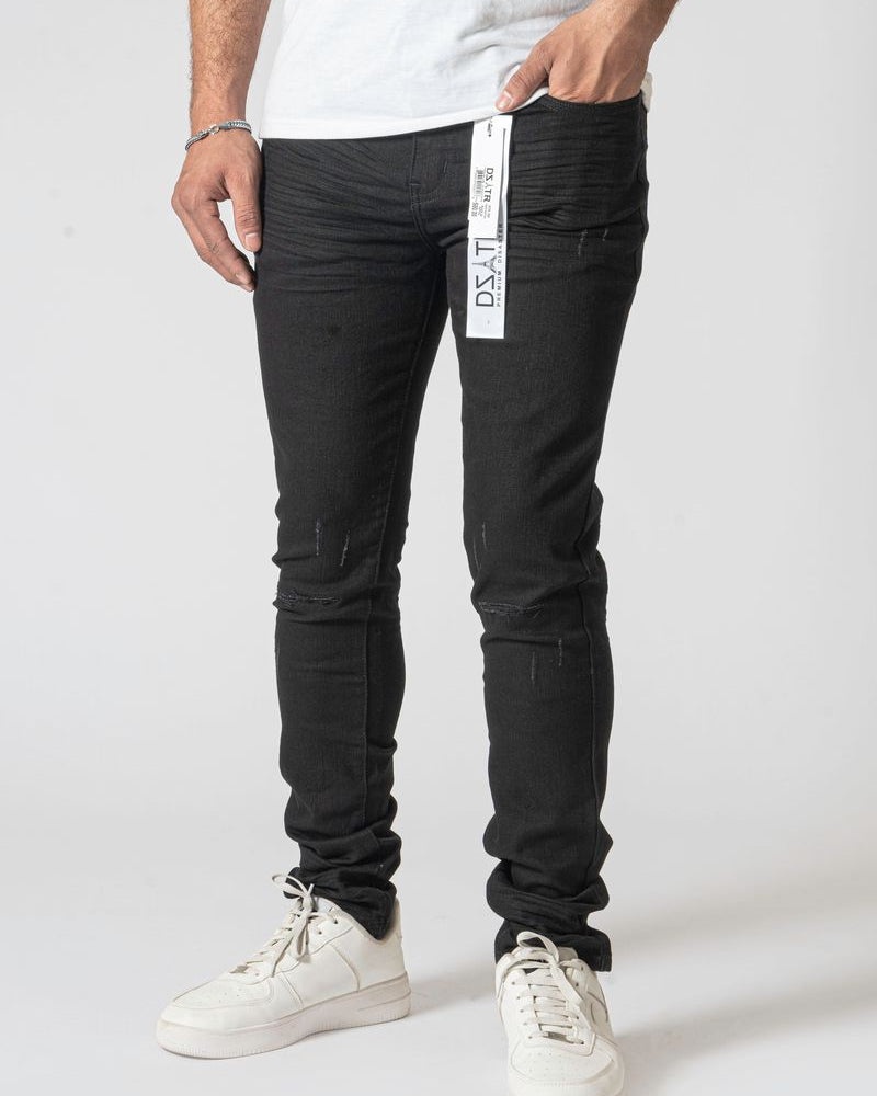 Person wearing black pants with a visible brand label on a white background