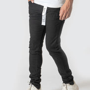 Person wearing black pants with a visible brand logo on a white background