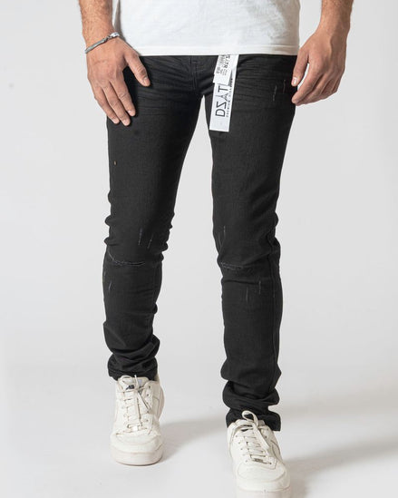 Person wearing black jeans with a visible brand label on a white background