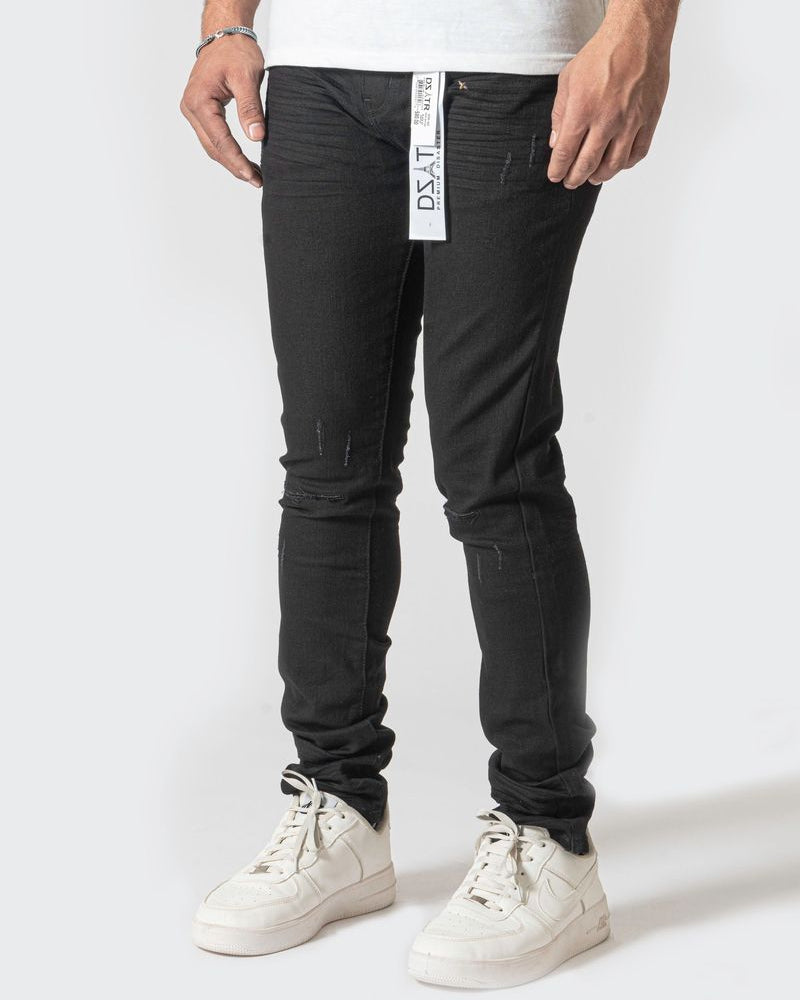 Person wearing black pants with a visible brand label on a white background