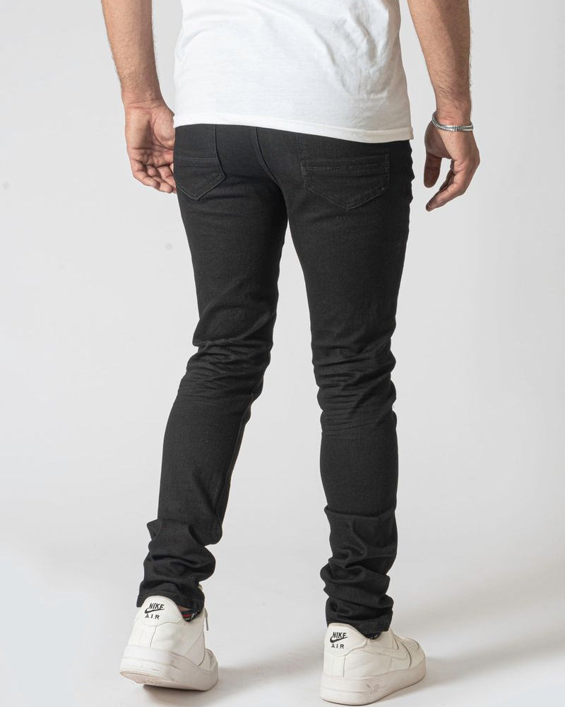 Person wearing black pants and white sneakers on a white background