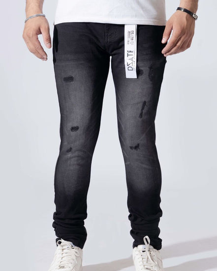 A person wearing slim-fit black distressed jeans with a white vertical Dst. Hy.