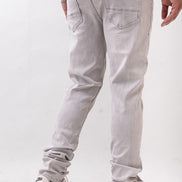 Person wearing light gray pants and white sneakers on a white background