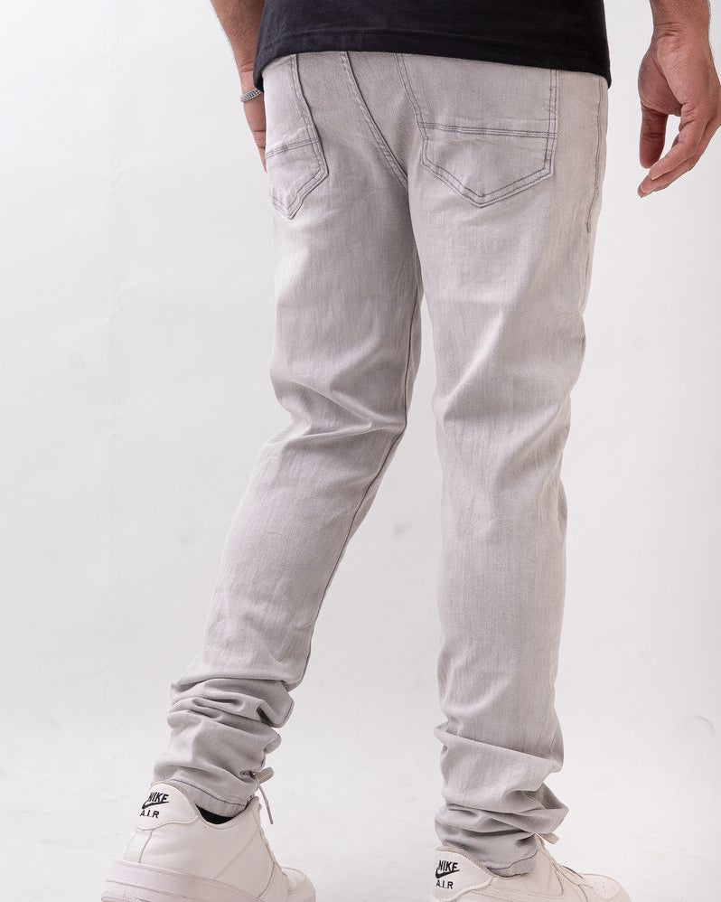 Person wearing light gray pants and white sneakers on a white background