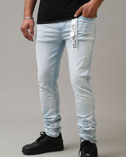 Light blue jeans with a brand label worn by a person on a gray background