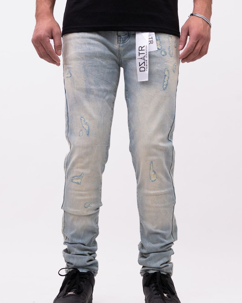Person wearing light blue distressed jeans with a black shirt on a white background