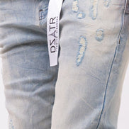 Light blue distressed jeans with a visible brand label on a white background