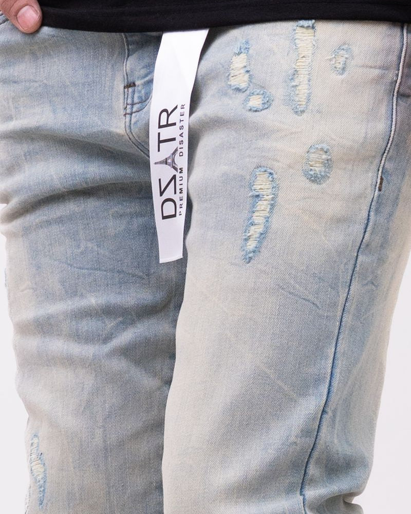 Light blue distressed jeans with a visible brand label on a white background