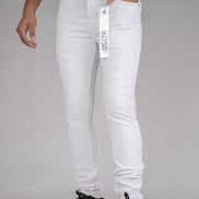 White jeans with a brand tag displayed on a gray background