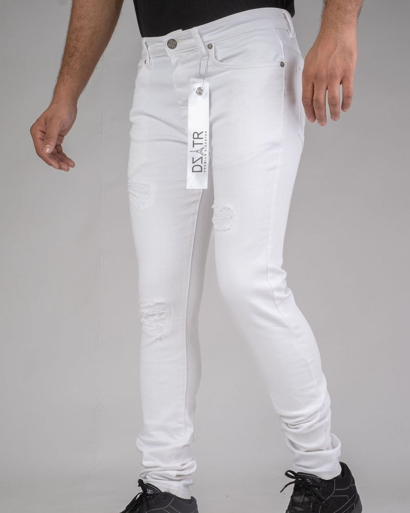White jeans with a brand tag on a plain background