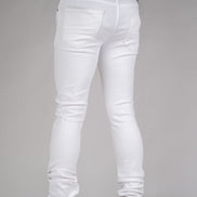White jeans worn by a person on a gray background