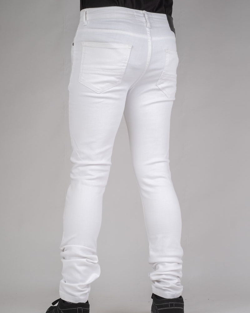 White jeans worn by a person on a gray background