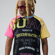 Person wearing a colorful t-shirt with text and graphics on a gray background