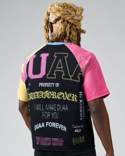 Person wearing a colorful t-shirt with text and graphics on a gray background