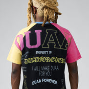 Person wearing a colorful t-shirt with text on the back against a gray background