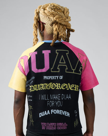 Person wearing a colorful t-shirt with text on the back against a gray background
