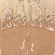 Brown jacket with 'RARE' text in white sequins and beads