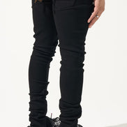 Person wearing black jeans and colorful sneakers on a white background