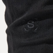 Close-up of a black fabric with a logo on a white background