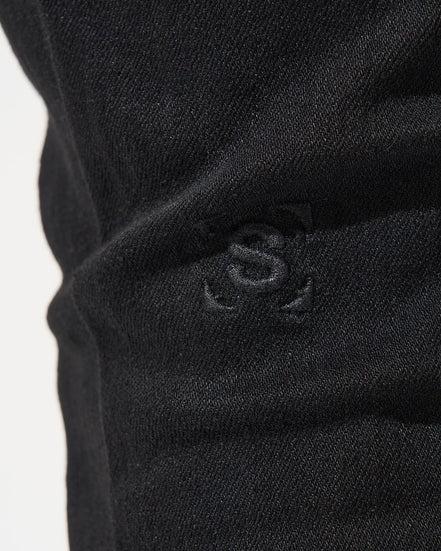 Close-up of a black fabric with a logo on a white background