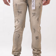 Beige distressed jeans worn by a person on a white background