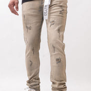 Beige distressed jeans worn by a person on a white background