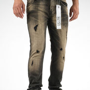 Distressed jeans with a brand tag on a white background