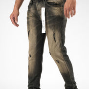 Distressed black jeans with a tag on a white background