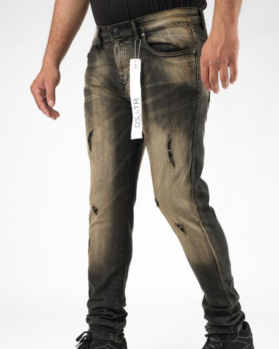 Distressed black jeans with a tag on a white background
