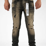 Distressed black jeans with a brand tag on a white background