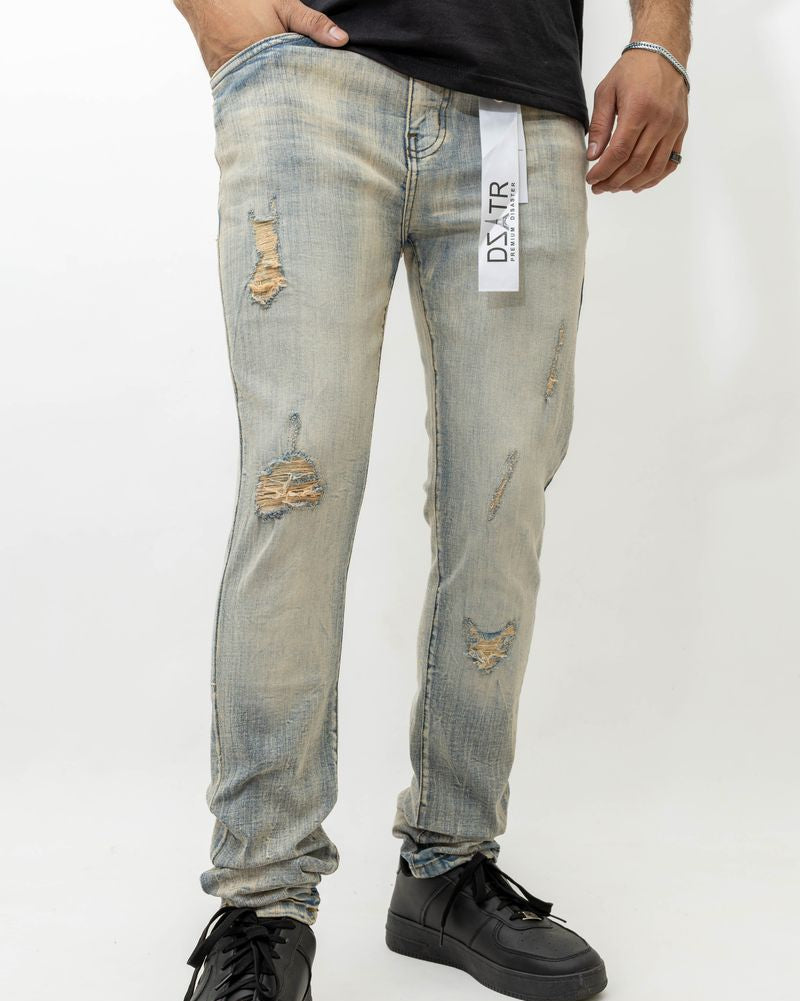 Person wearing distressed light blue jeans with a visible brand label on a white background