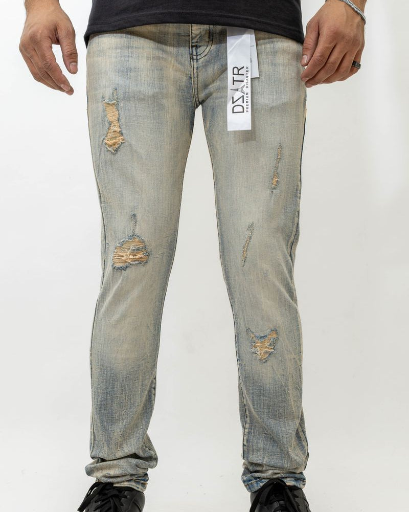 Person wearing distressed light blue jeans with a visible brand tag on a white background
