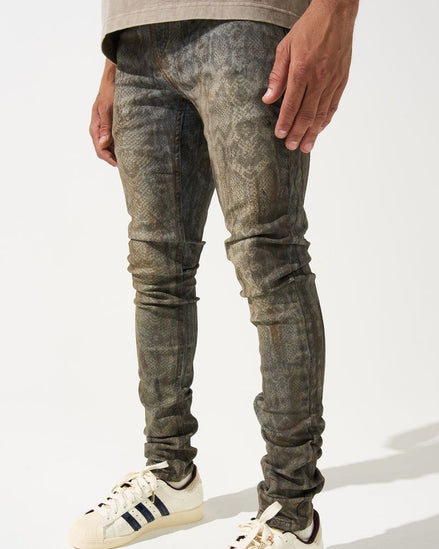 Person wearing distressed gray jeans and white Adidas sneakers on a white background