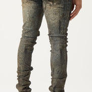 Person wearing distressed gray jeans and white sneakers with black stripes on a plain background