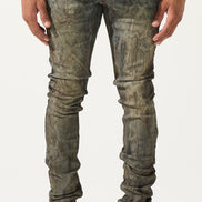 Person wearing distressed gray jeans and white sneakers on a white background