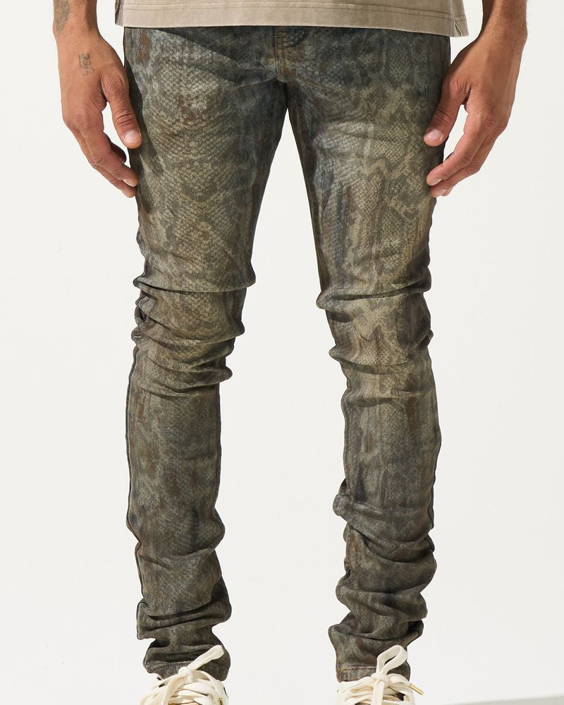 Person wearing distressed gray jeans and white sneakers on a white background