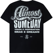 A black short-sleeve t-shirt shown from the back, featuring a large white graphic print that reads 'Almost Someday' with 'VISION & INSPIRATION IDEAS & DREAMS' underneath.